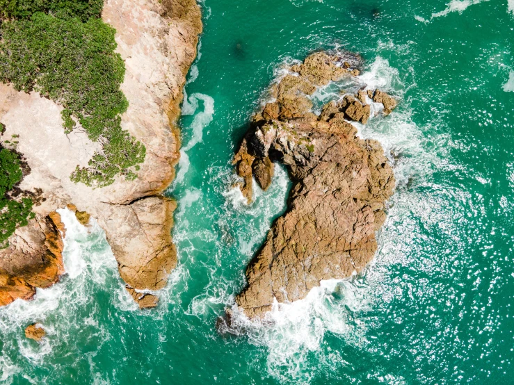 there is a rock in the water between two other rocks