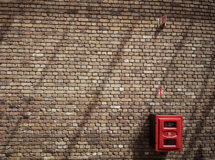 a red brick wall with a switch in front of it