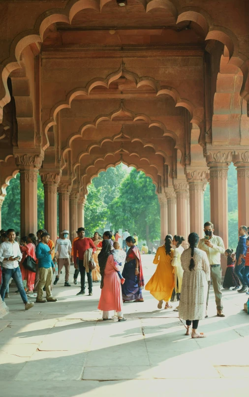 a large group of people gathered in the shade