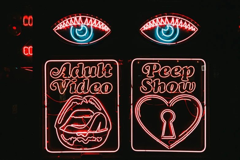 two neon signs that are both with eyes