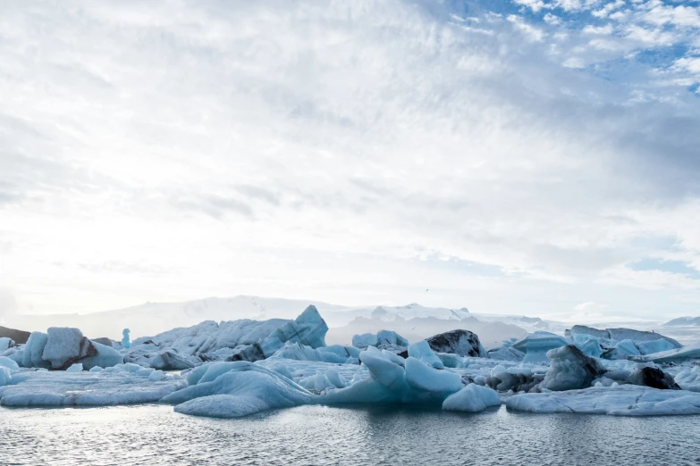 a very cloudy sky that has some blue ice