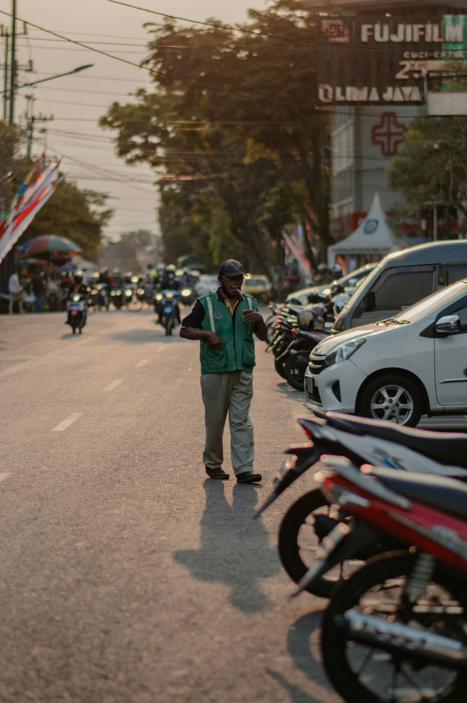 a man is on the street next to many parked motorcycles