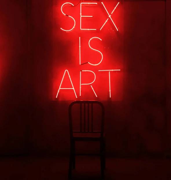 a red neon sign reads sex is art