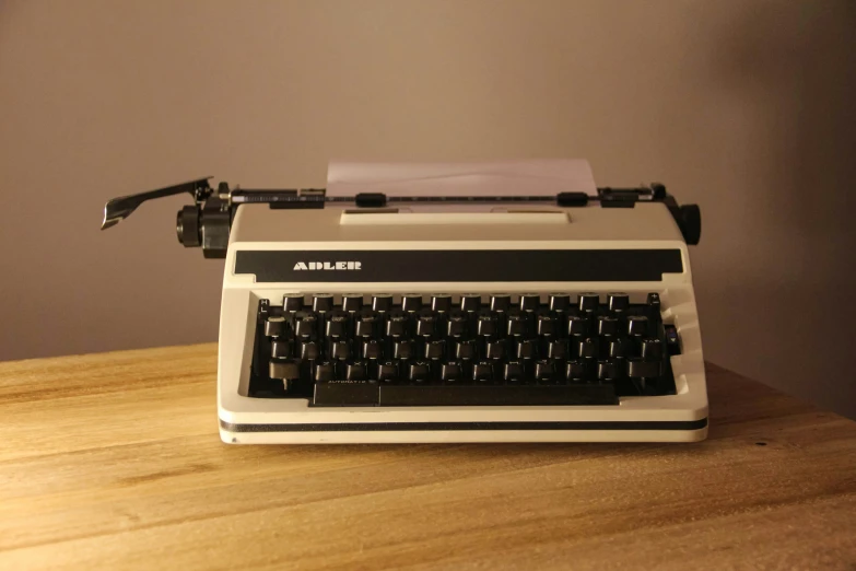 a white and black typewriter on top of a table