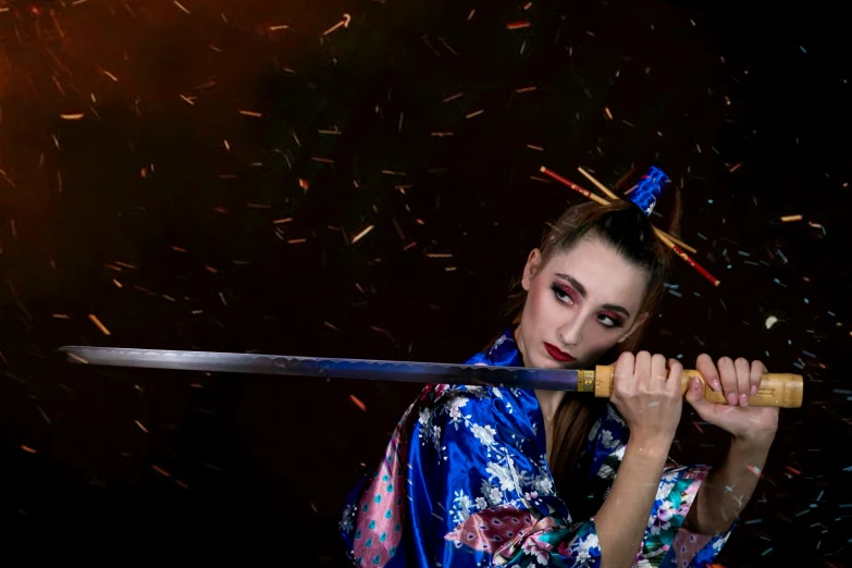 a woman in a kimono holding a sword near fireworks