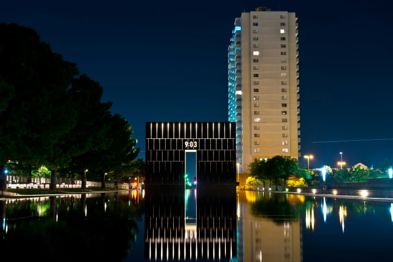 two tall buildings sitting beside the water in a city