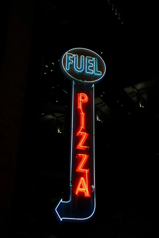 neon sign for a gas station at night