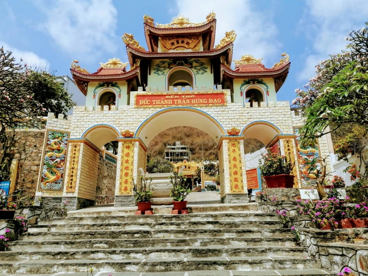 a white and yellow building has stairs leading up to it