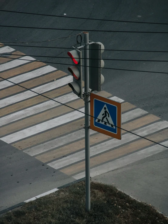 a sign for a pedestrian crossing is at the crosswalk