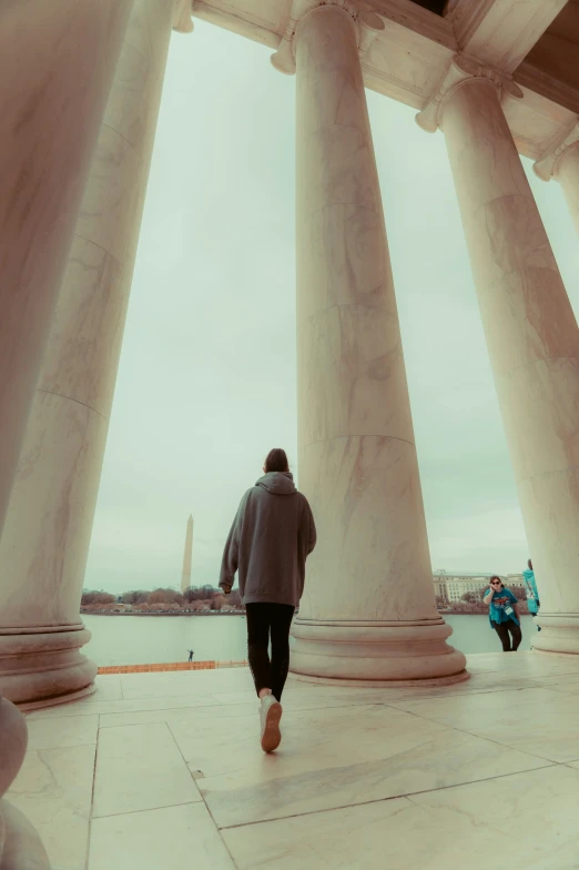 a man walking through the stone covered area