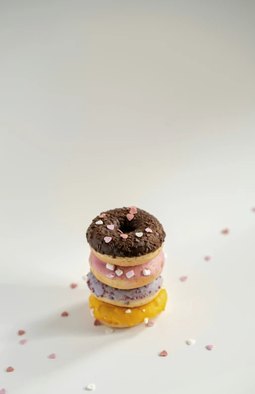 four donuts stacked up in front of each other on top of a table