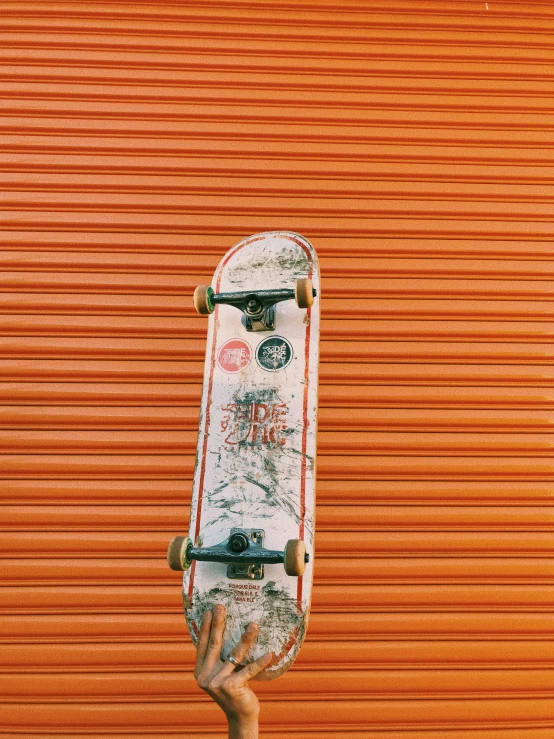 a skateboard in front of a red wall