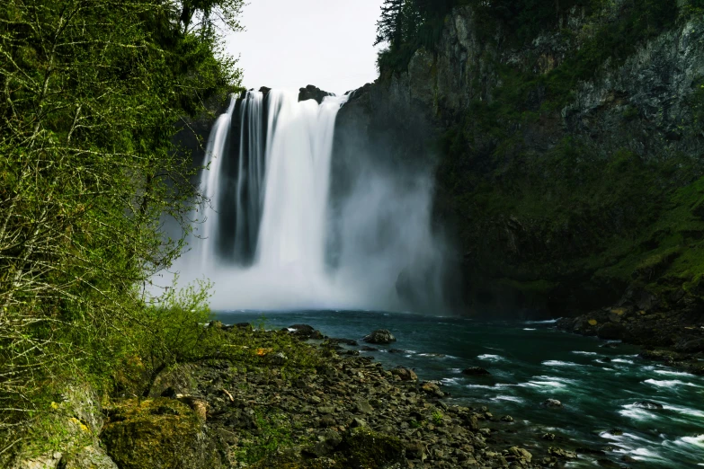 a waterfall that is pouring out of a river