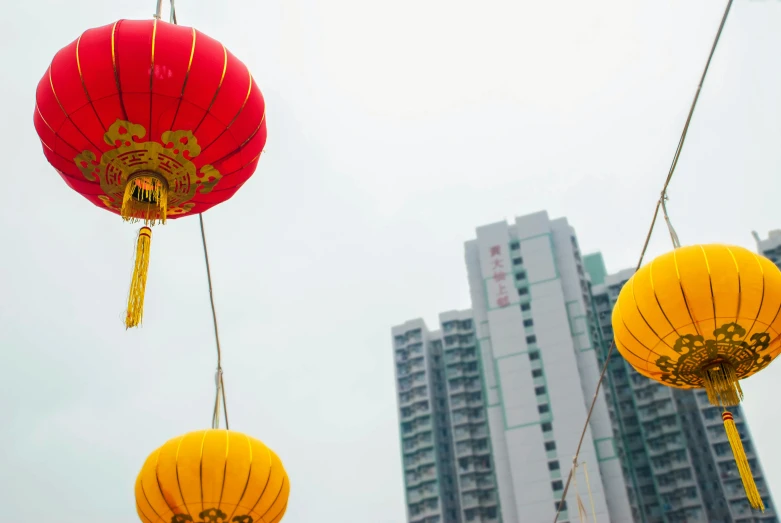 chinese lanterns with a view of some tall buildings in the background