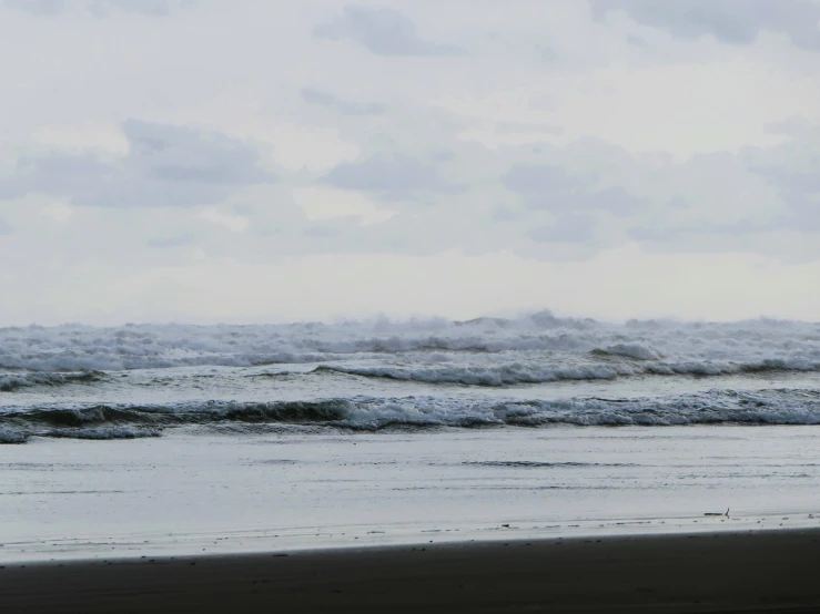 a view of the ocean with waves coming in and out