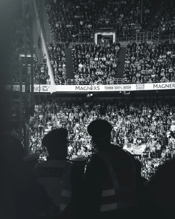 group of people in front of fans on a basketball court