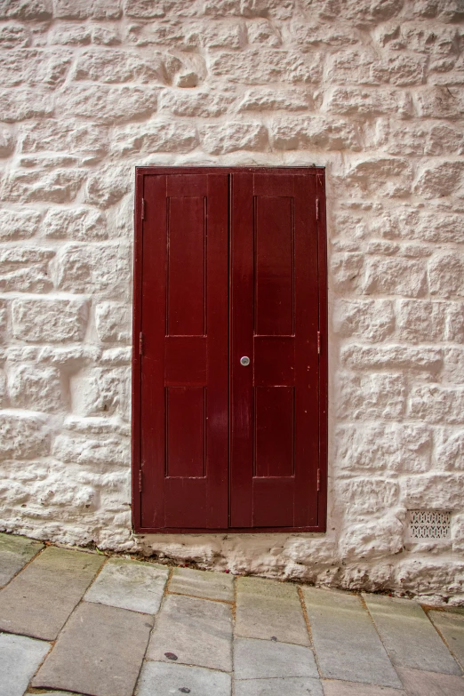 a red door that is on the side of a building