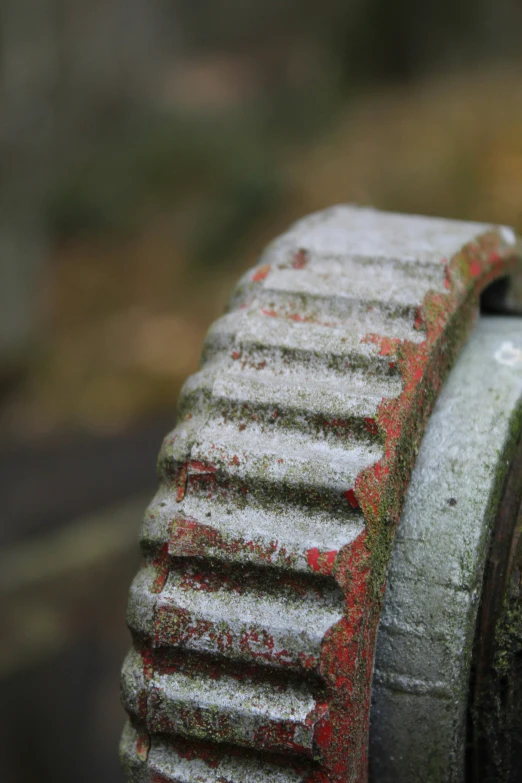 a rusted red and white fire hydrant with some snow on the bottom