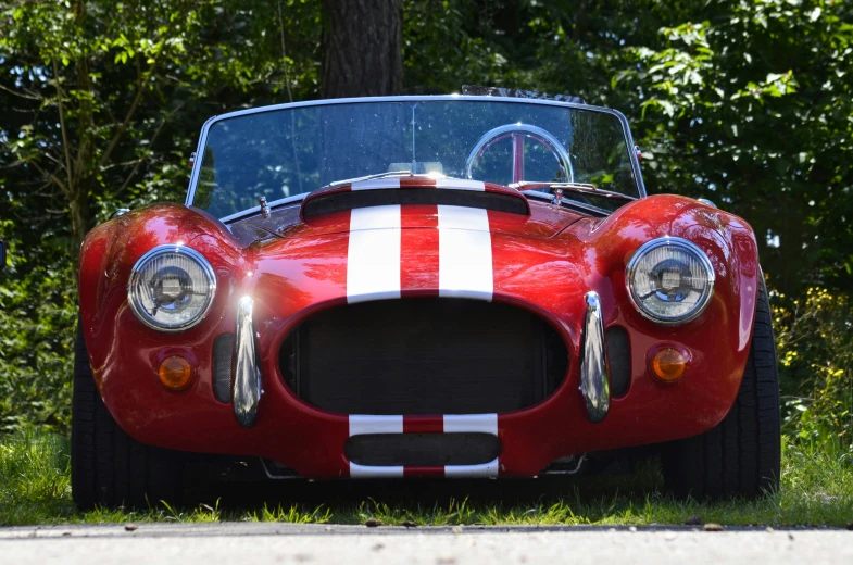 the front of an old red sports car