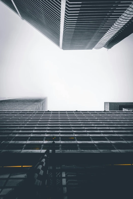 a tall building towering into the sky under a cloud