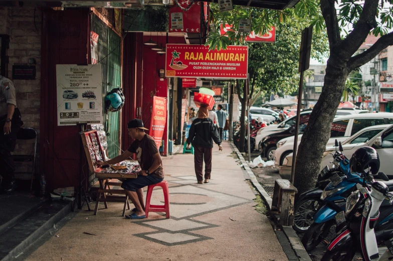 a man and woman are sitting on the sidewalk