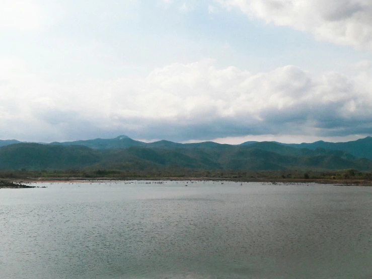 a boat on the water during a cloudy day