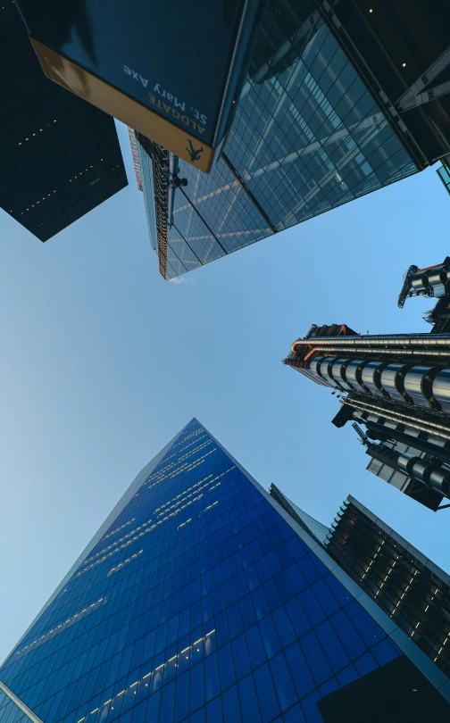 looking up at tall skyscrs in a city