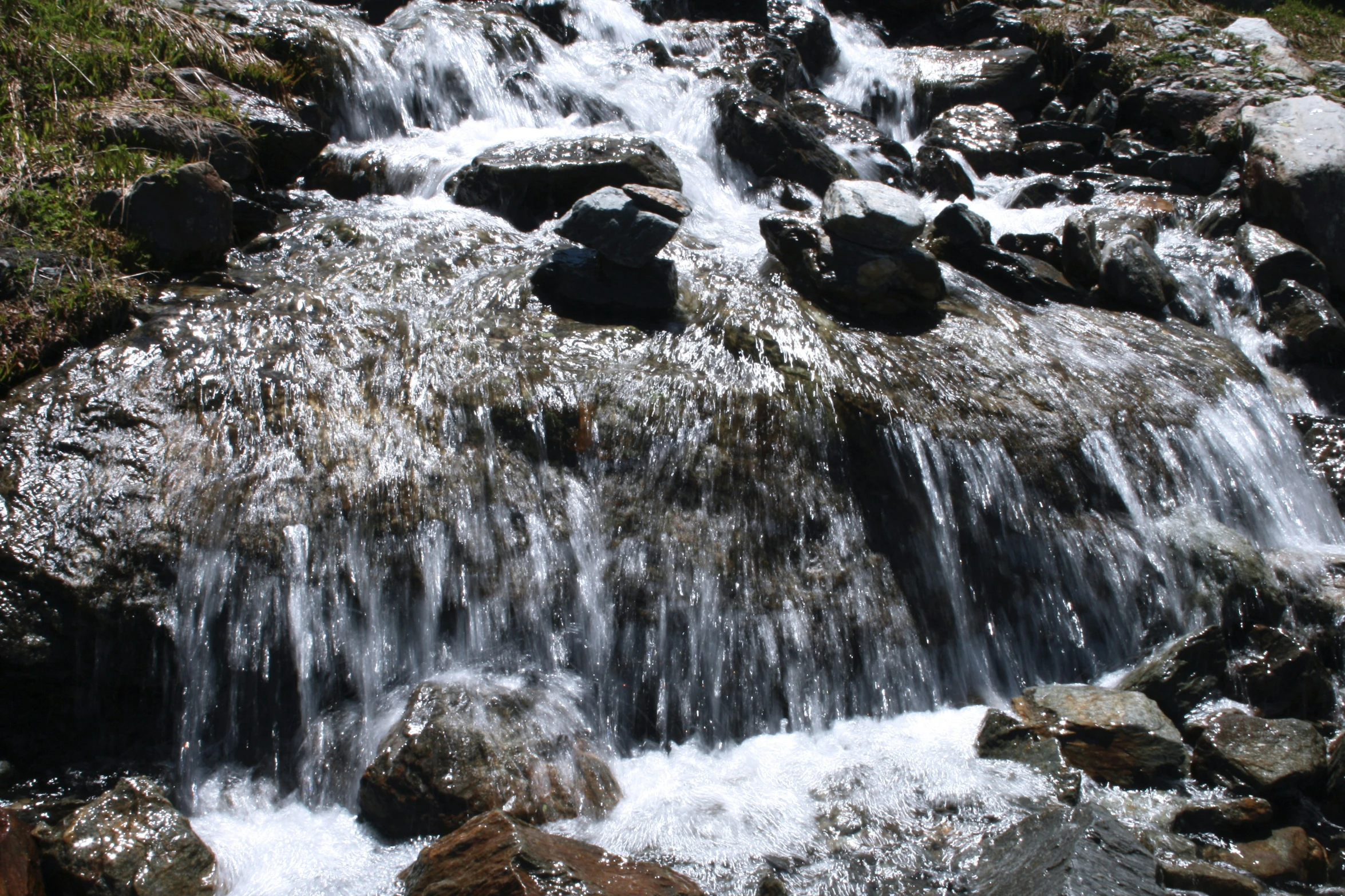 water pouring from the top of a rocky outcropping