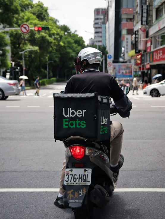 a person on a motorbike riding down a busy street