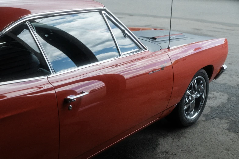 a red car parked on the street and looking out the back door