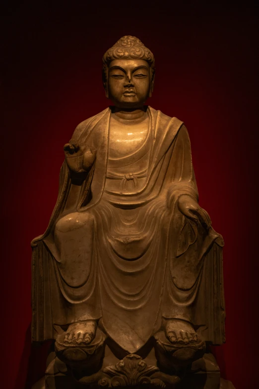 the buddha statue looks to be in a dark room