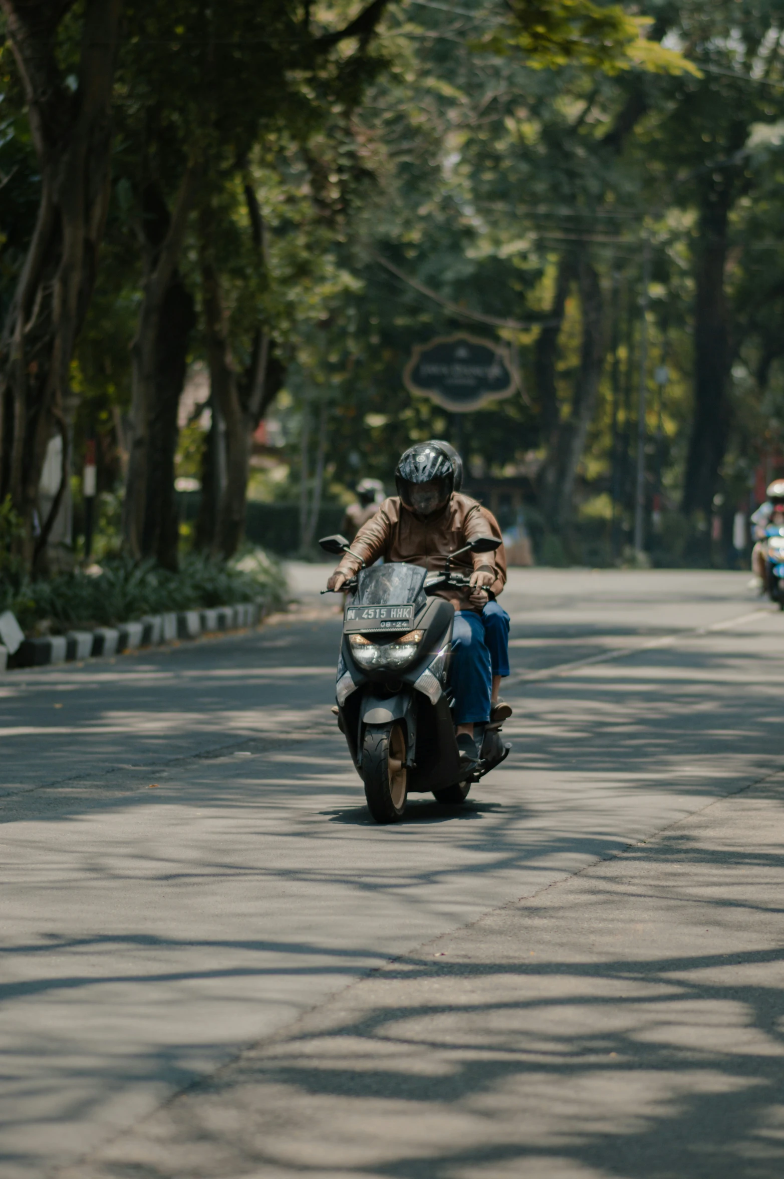 two people are riding on a motor bike