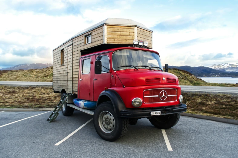 an old red truck with its bed on the trailer