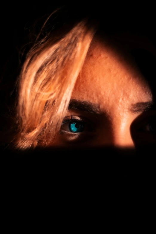 a person with blue eyes in the dark