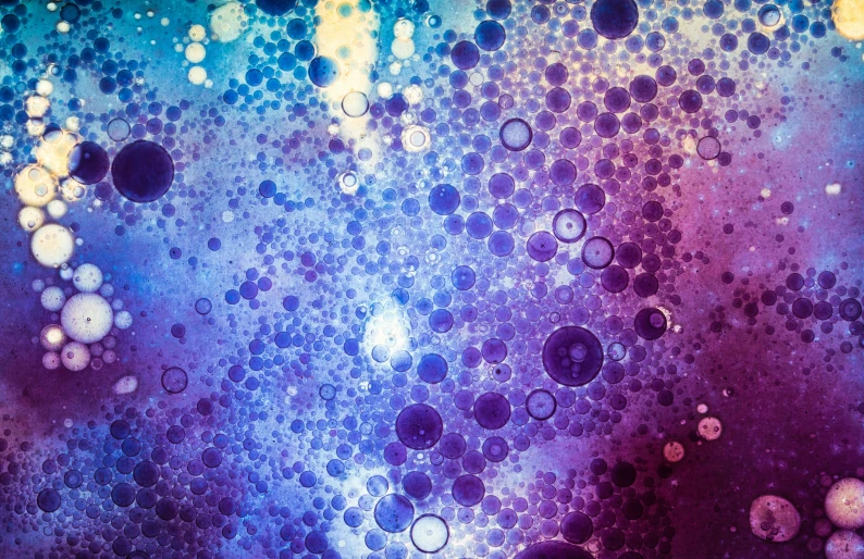 drops of water on a purple and blue surface