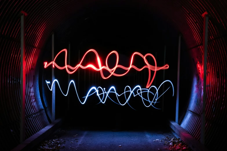 a tunnel with lights on in it that is red and white