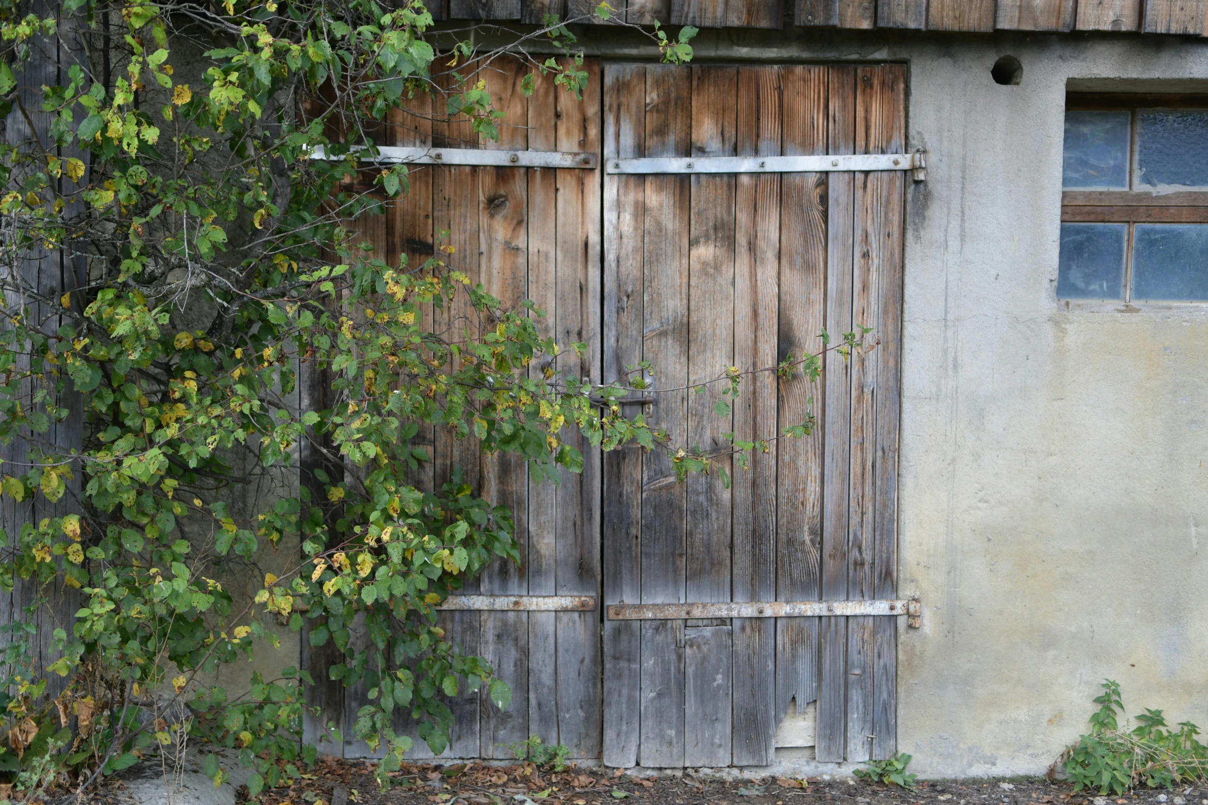 an old wooden door that is being boarded in