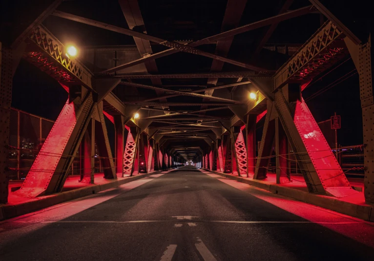 a night time view of a red bridge