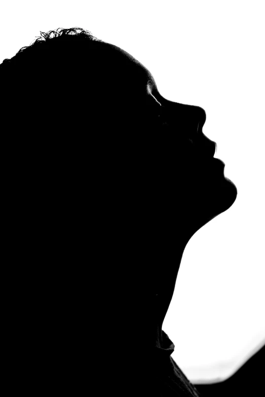 a person with their head turned sideways in silhouette
