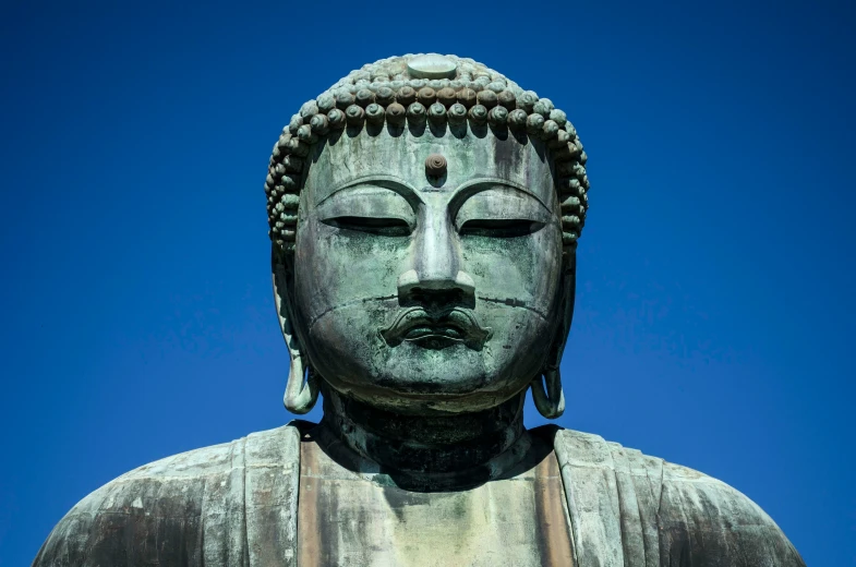 there is a large buddha statue with eyes closed