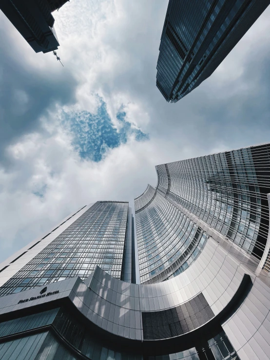 tall buildings and a cloudy sky, looking up