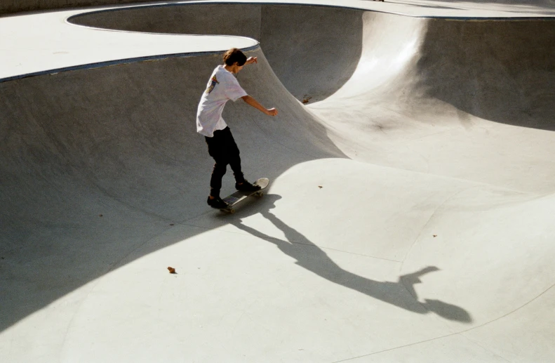 a person on a skateboard rides the inside of a skate park