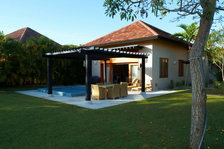 a house sits near a small swimming pool