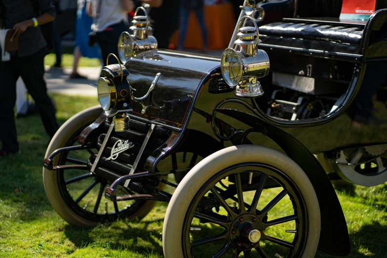 a close up of two old model cars on a grassy area