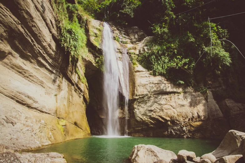 the waterfall has a long side walk over it