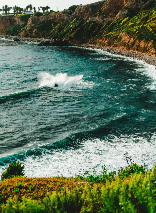 a person riding a wave on a surfboard