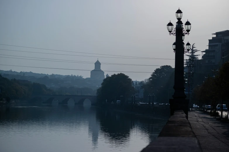 a river running through a city with a light house