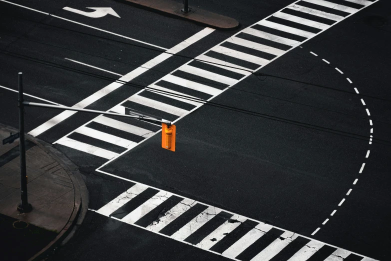 a pedestrian crosses the street at an intersection