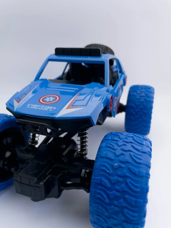 toy truck with blue body and tires on white background