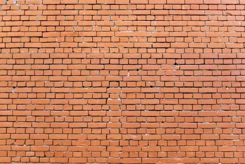 a red brick wall with a gray tiled top
